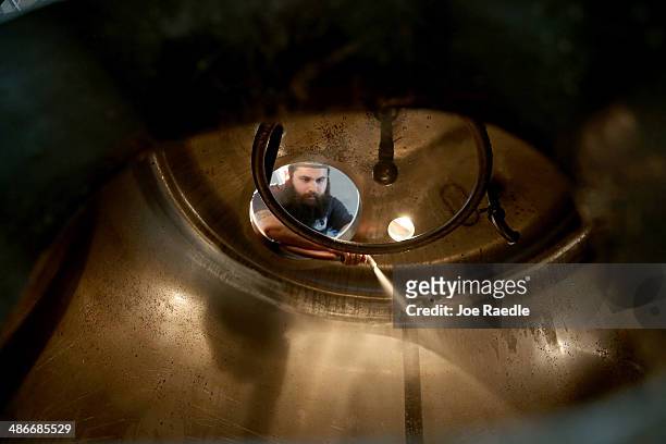 David Rodriguez, a beer brewer, cleans the inside of the mash tun at Wynwood Brewing Company on April 25, 2014 in Miami, Florida. Earlier this week...