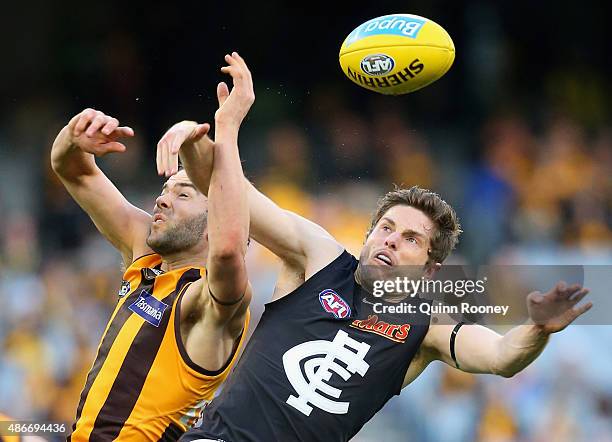 Jordan Lewis of the Hawks attempts to mark infront of Jason Tutt of the Blues during the round 23 AFL match between the Hawthorn Hawks and the...