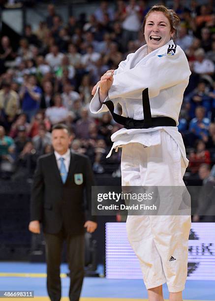 Kim Polling of Holland leaps high into the air with joy after throwing Laura Vargas-Kock of Germany for ippon to win the u70kg gold medal at the...