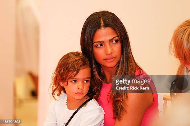 Host Camila Alves McConaughey and her daughter Vida McConaughey watch the Badgley Mischka Fashion Event at Neiman Marcus on April 25, 2014 in Austin,...