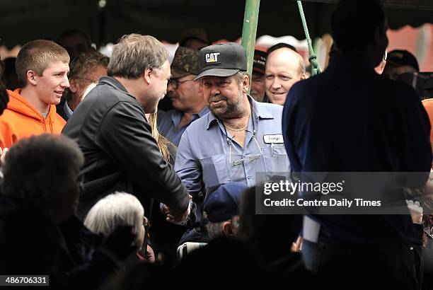 George Cowfer, center, is congratulated after his winning bid for a 1969 Ford Mustang Shelby GT500 on Friday, April 25 in Centre Hall, Pa. Ron...