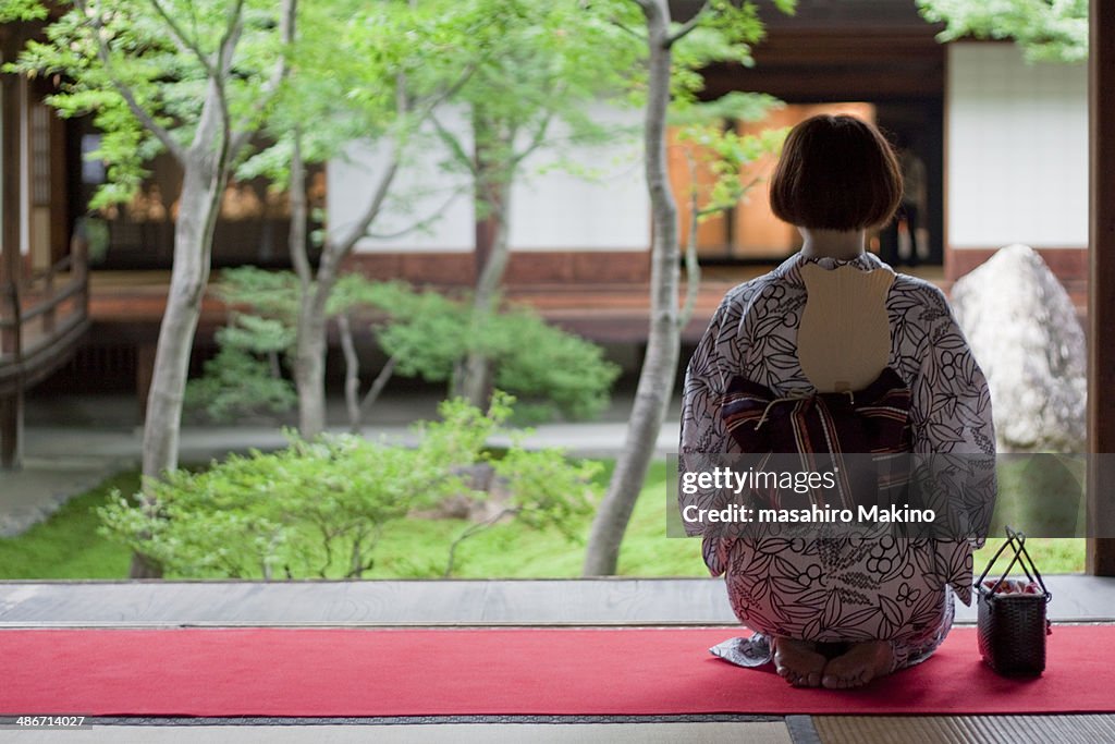 Woman in kimono meditating.