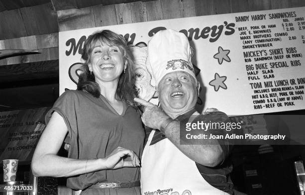 Actor Mickey Rooney with actress Terry 'Teri' Garr during festivities at the opening of his 'Mickey Rooney's Star-B-Q' restaurant, featuring menu...