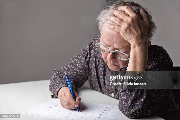 illiterate woman learning to write - illiteracy stock pictures, royalty-free photos & images