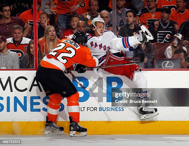 Carl Hagelin of the New York Rangers is hit by Luke Schenn of the Philadelphia Flyers during the first period in Game Four of the First Round of the...