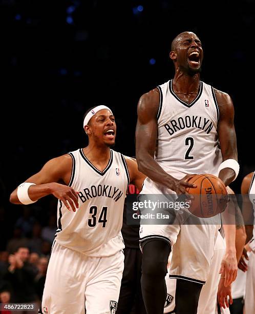 Kevin Garnett of the Brooklyn Nets celebrates after he got the loose ball with teammate Paul Pierce in the second quarter against the Toronto Raptors...