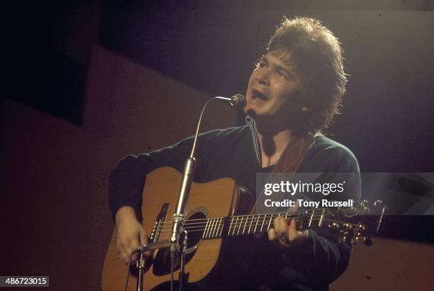 Musician John Prine on stage, circa 1970-1975.