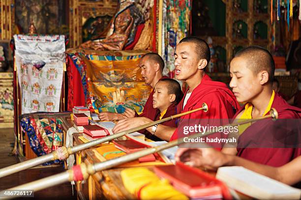 tibetan monks praying during puja - buddhist scriptures stock pictures, royalty-free photos & images