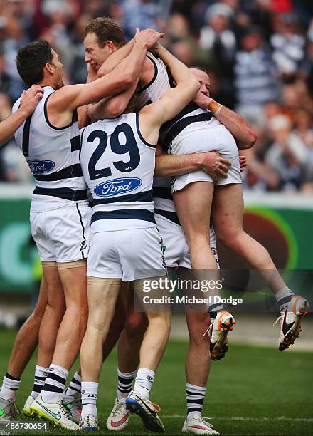 Steve Johnson of the Cats celebrates a goal with teammates during the round 23 AFL match between the Geelong Cats and the Adelaide Crows at Simonds...