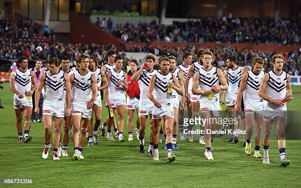 The Dockers players walk from the field after the round 23 AFL match between the Port Adelaide Power and the Fremantle Dockers at Adelaide Oval on...