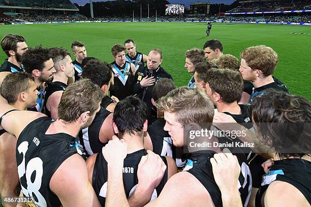 Ken Hinkley the coach of the Power addresses his players after the round 23 AFL match between the Port Adelaide Power and the Fremantle Dockers at...