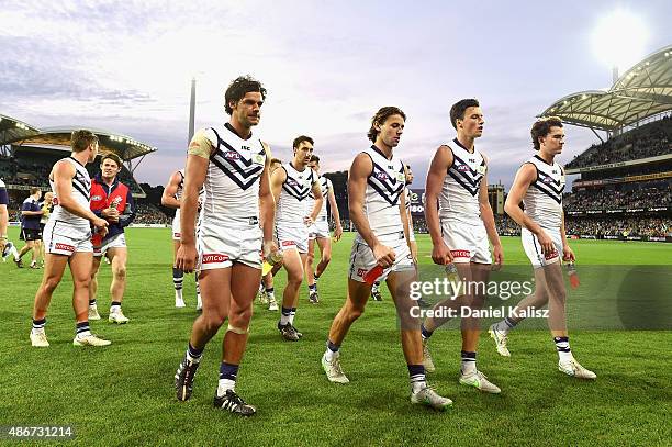 The Dockers players walk from the field after the round 23 AFL match between the Port Adelaide Power and the Fremantle Dockers at Adelaide Oval on...