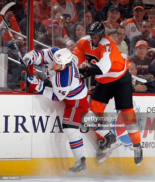 Derek Dorsett of the New York Rangers is hit by Wayne Simmonds of the Philadelphia Flyers during the second period in Game Four of the First Round of...