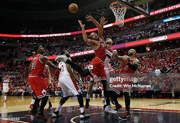 Joakim Noah of the Chicago Bulls has his shot rejected by Marcin Gortat of the Washington Wizards in first quarter action of Game 3 of the Eastern...