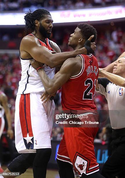 Washington Wizards forward Nene Hilario and Chicago Bulls guard Jimmy Butler get into an altercation during the second half of their first round...