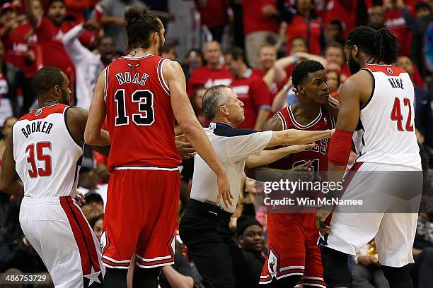 Nen of the Washington Wizards scuffles with Jimmy Butler of the Chicago Bulls in fourth quarter action of Game 3 of the Eastern Conference...