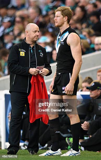 Power official holds the red substitue vest during the round 23 AFL match between the Port Adelaide Power and the Fremantle Dockers at Adelaide Oval...