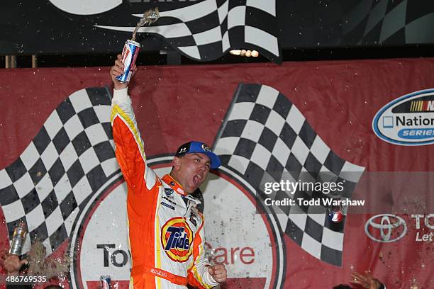 Kevin Harvick, driver of the Tide Chevrolet, celebrates in Victory Lane after winning the NASCAR Nationwide Series ToyotaCare 250 at Richmond...