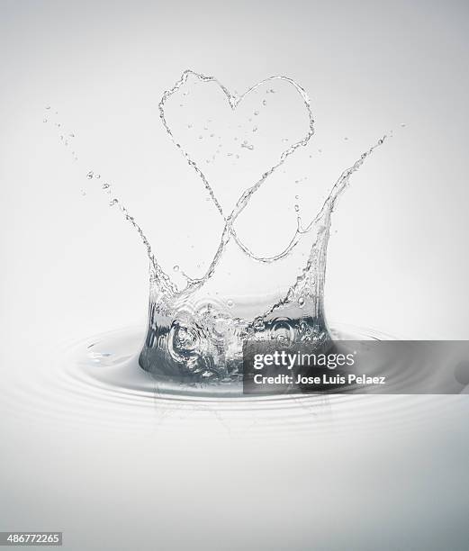 clean water splash with heart shape - splash crown stock pictures, royalty-free photos & images