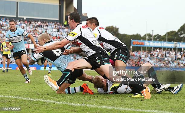 Todd Carney of the Sharks is tackled short of the try line but still scores a try during the round 8 NRL match between the Cronulla-Sutherland Sharks...