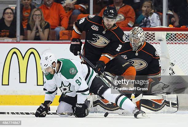 Tyler Seguin of the Dallas Stars is checked to the ice by Mark Fistric of the Anaheim Ducks, as goaltender Frederik Andersen defends his net in the...