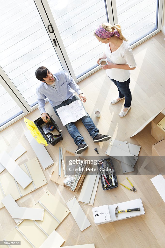 Couple surrounded by unassembled furniture