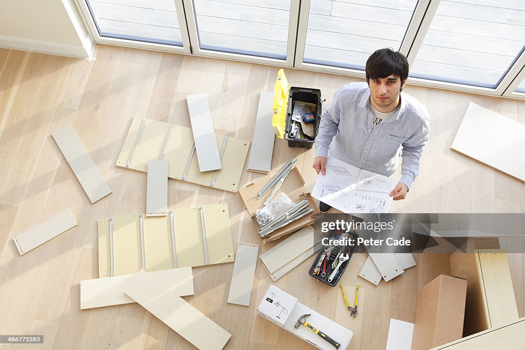 Unassembled Chair Man Surrounded By Unassembled Furniture High-Res Stock Photo - Getty Images