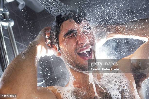 man in shower, rinsing shampoo from hair - men taking shower stock-fotos und bilder