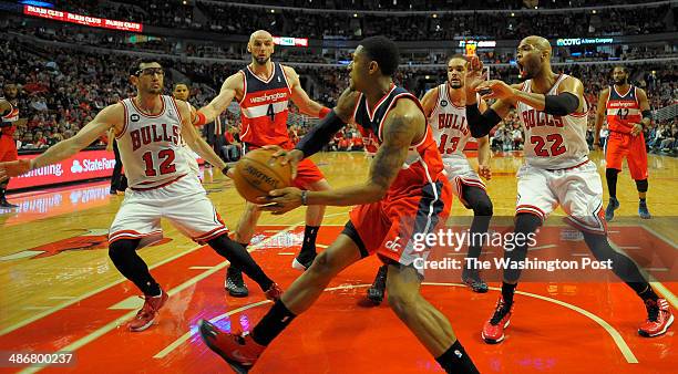 Washington guard Bradley Beal , center, maneuvers under the basket to pass off in the 1st half during the Washington Wizards defeat of the Chicago...