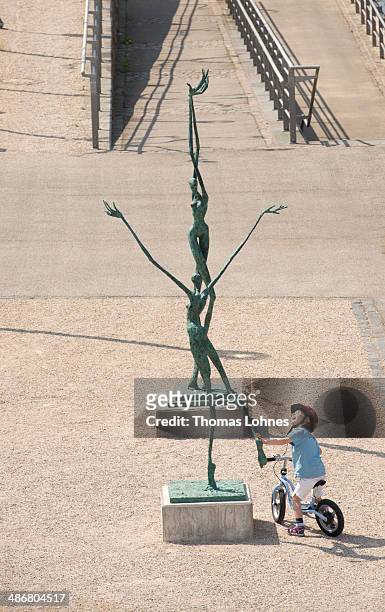 Small boy looks to the artwork of Helge Leiberg 'Abheben' on April 25, 2014 in Bingen, Germany. The 'Sculpture Triennial 2014' will take place in...