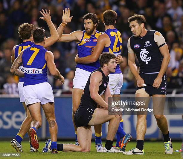 Josh Kennedy of the Eagles celebrates a goal with teamates as Sam Rowe and Michael Jamison of the Blues react during the round six AFL match between...