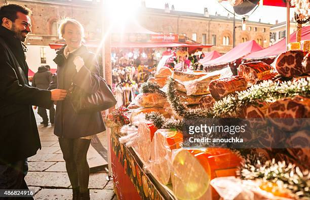 couple visiting christmas market, milan - milan food stock pictures, royalty-free photos & images