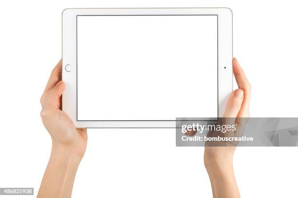 hands holding touch screen apple ipad air2 - hands holding ipad stock pictures, royalty-free photos & images