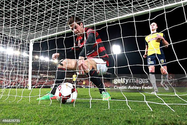 Iacopo La Rocca of the Wanderers picks up the ball after scoring a goal with Zachary Anderson of the Mariners looking dejected in the background...