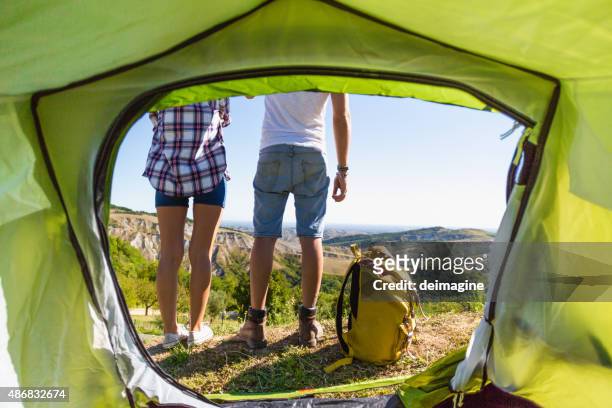 couple admires the scenery outside the tent - marquee stock pictures, royalty-free photos & images
