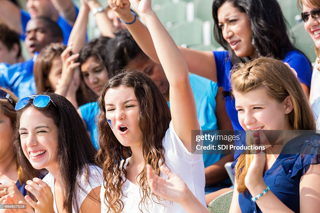 High school sports fans cheering for team in stadium