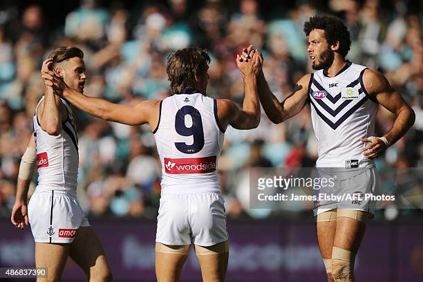 Hayden Crozier, Matt de Boer and Zac Clarke of the Dockers celebrate a goal during the 2015 AFL round 23 match between Port Adelaide Power and the...