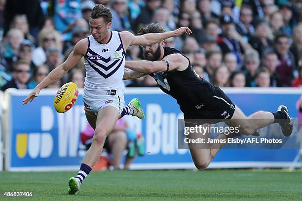 Ed Langdon of the Dockers is tackled by Justin Westhoff of the Power during the 2015 AFL round 23 match between Port Adelaide Power and the Fremantle...