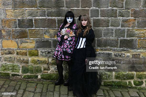 Two girls pose for the camera during the Goth weekend on April 26, 2014 in Whitby, England. The Whitby Goth weekend began in 1994 and happens twice...