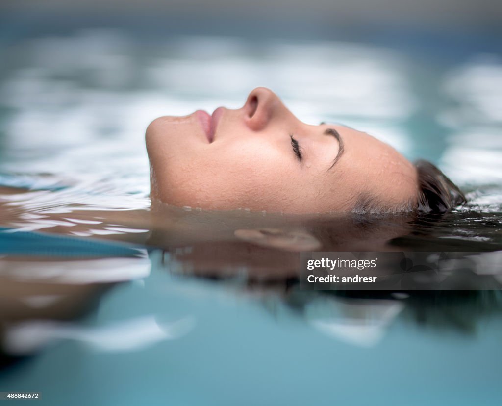 Woman at the spa relaxing at the swimming pool