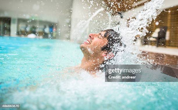 man at the spa enjoying the hydrotherapy - hydrotherapy stock pictures, royalty-free photos & images