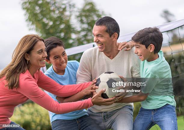 family fighting for a soccer ball - fighting game stock pictures, royalty-free photos & images