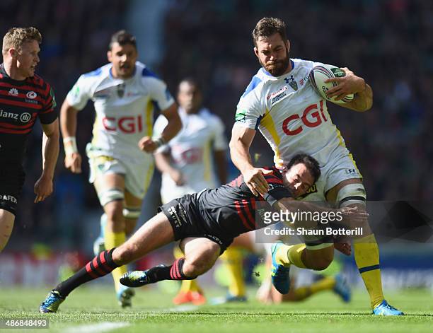 Jamie Cudmore of ASM Clermont Auvergne is tackled by Neil de Kock of Saracens during the Heineken Cup Semi-Final match between Saracens and ASM...