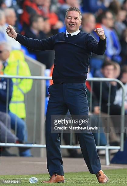 Darren Ferguson, manager of Peterborough United celebrates his teams fourth goal during the Sky Bet League One match between Shrewsbury Town and...