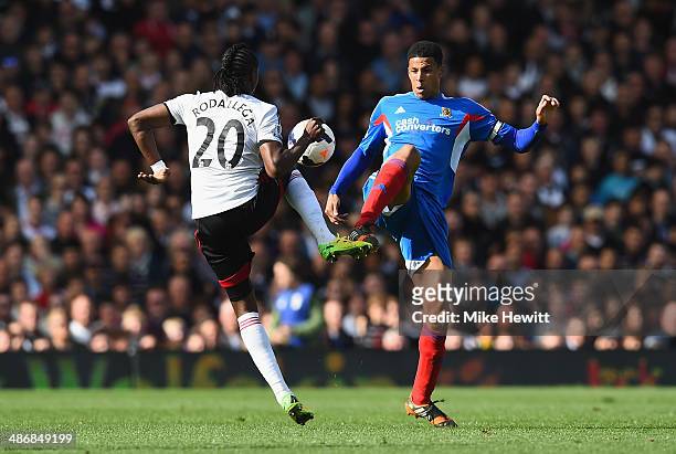 Hugo Rodallega of Fulham is challenged by Curtis Davies of Hull during the Barclays Premier League match between Fulham and Hull City at Craven...