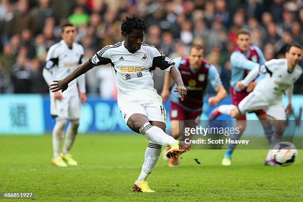 Wilfried Bony of Swansea City scores their fourth goal from the penalty spot during the Barclays Premier League match between Swansea City and Aston...
