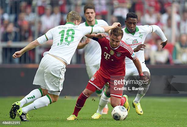 Mario Goetze of Muenchen is challenged by Felix Kroos and Eljero Elia of Bremen during the Bundesliga match between Bayern Muenchen and Werder Bremen...