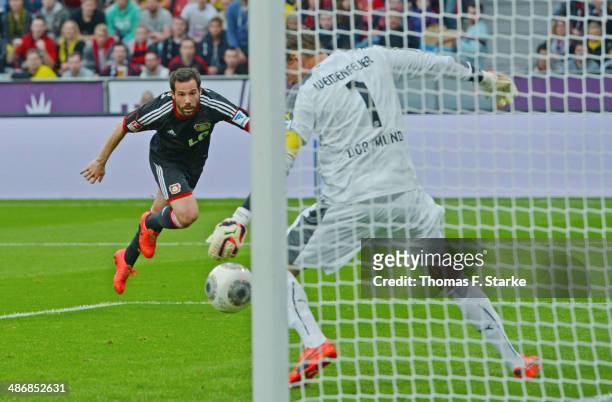 Gonzalo Castro of Leverkusen scores his teams second goal against goalkeeper Roman Weidenfeller of Dortmund during the Bundesliga match between Bayer...