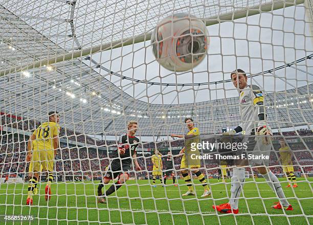Stefan Kiessling of Leverkusen celebrates his teams first goal while Nuri Sahin , Mats Hummels and goalkeeper Roman Weidenfeller of Dortmund look...
