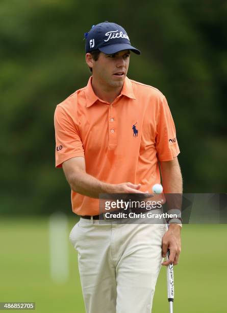 Ben Martin tosses his ball to his caddy after putting on the 1st during Round Three of the Zurich Classic of New Orleans at TPC Louisiana on April...
